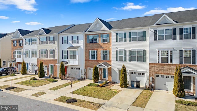 townhome / multi-family property featuring brick siding, a residential view, an attached garage, and driveway