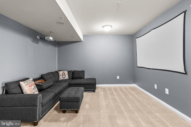 carpeted home theater featuring baseboards