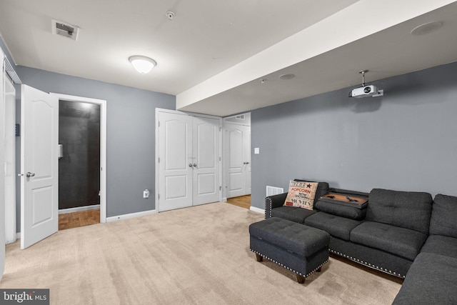 carpeted living room featuring baseboards and visible vents