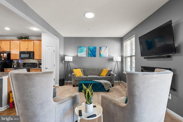 living room featuring recessed lighting, baseboards, and light colored carpet