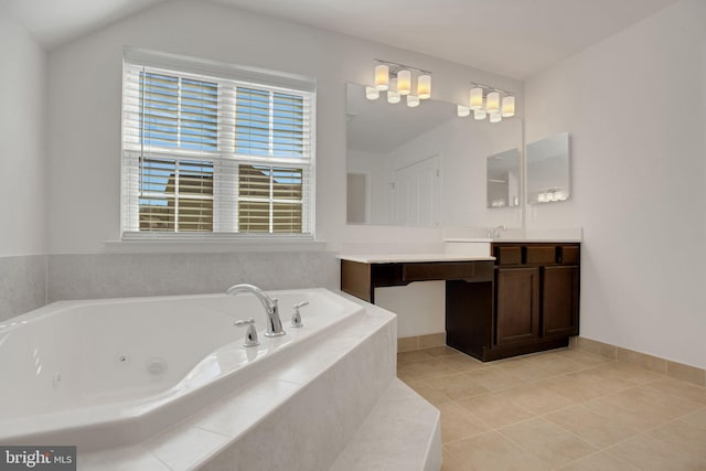 full bathroom featuring a tub with jets, tile patterned floors, and vanity