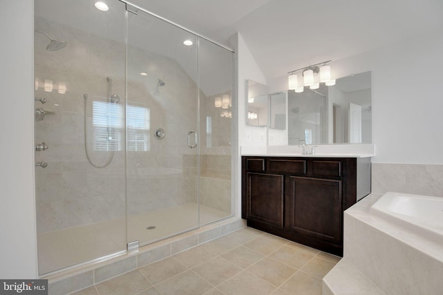full bathroom featuring tile patterned floors, vanity, a shower stall, lofted ceiling, and a bath