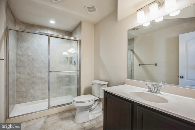 full bathroom featuring toilet, vanity, a stall shower, and visible vents
