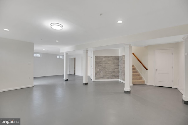 basement featuring stairs, baseboards, and recessed lighting