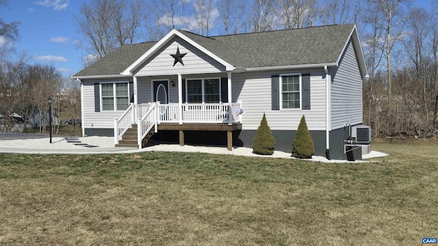 view of front of house featuring a front yard, central AC unit, covered porch, and roof with shingles