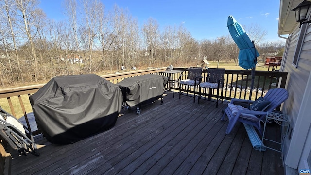 wooden terrace with a grill