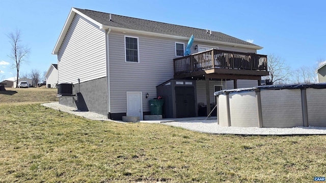 back of house featuring cooling unit, a yard, and a deck