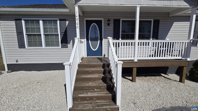 view of exterior entry with a porch