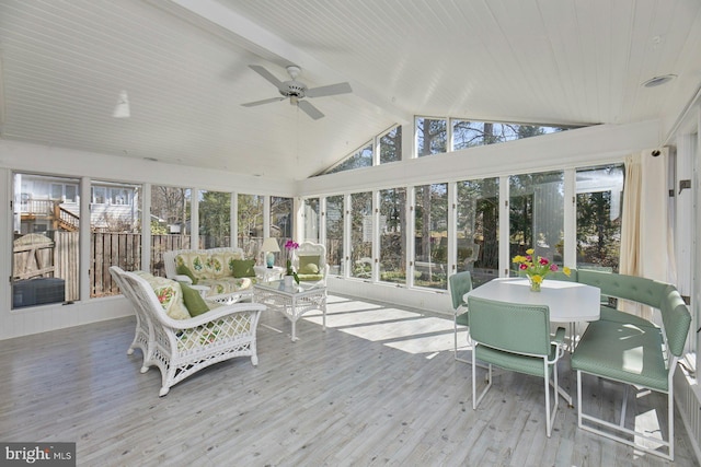 sunroom with vaulted ceiling with beams and a ceiling fan