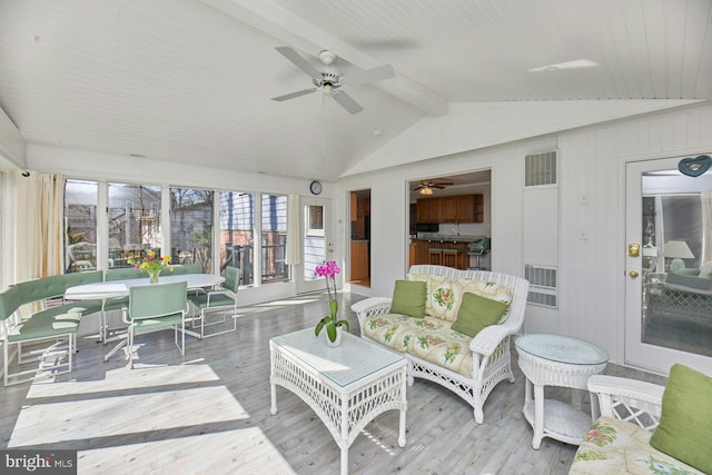 sunroom / solarium featuring vaulted ceiling with beams, a ceiling fan, and visible vents