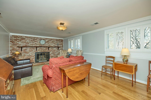 living room with visible vents, a healthy amount of sunlight, and crown molding