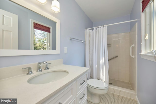 full bath featuring tile patterned floors, a stall shower, toilet, and vanity