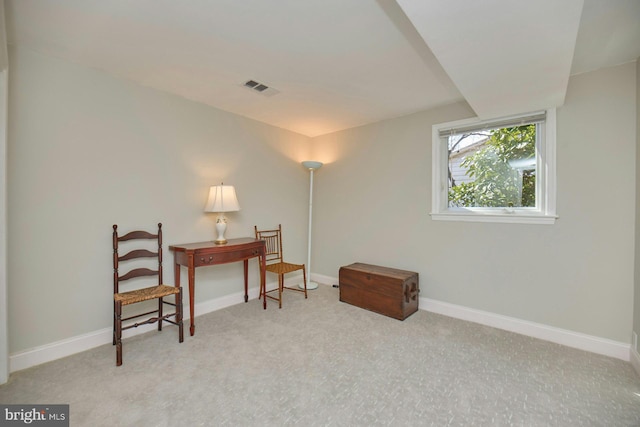 living area with carpet, baseboards, and visible vents