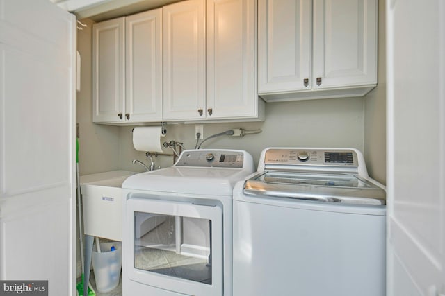 washroom with cabinet space and washing machine and dryer