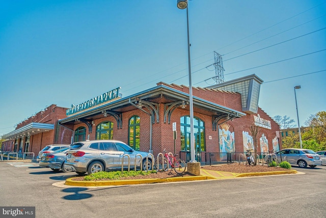 view of building exterior featuring uncovered parking