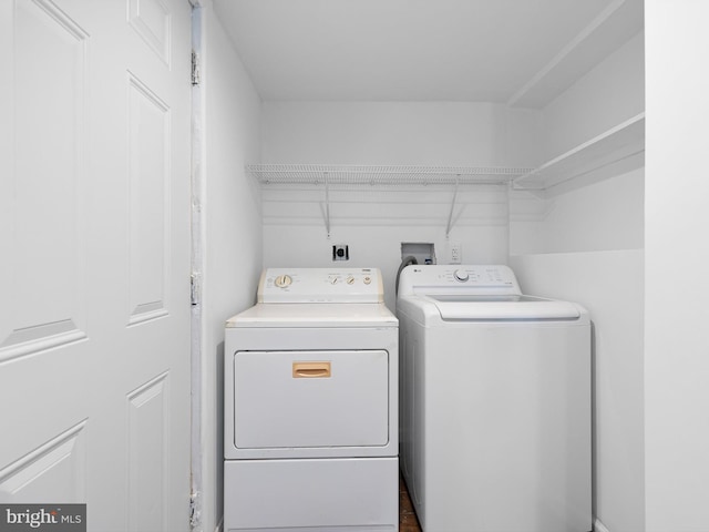 clothes washing area featuring washing machine and clothes dryer and laundry area