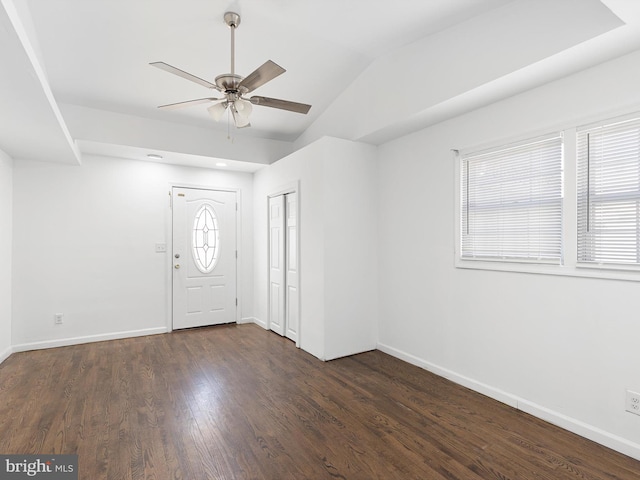 entrance foyer featuring dark wood finished floors, vaulted ceiling, baseboards, and ceiling fan