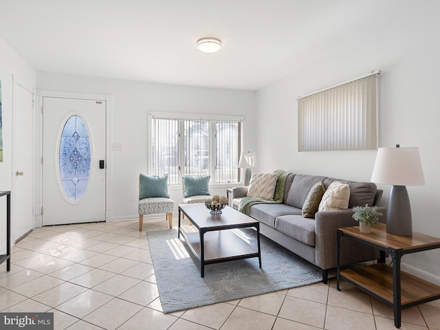 living room featuring light tile patterned floors and baseboards