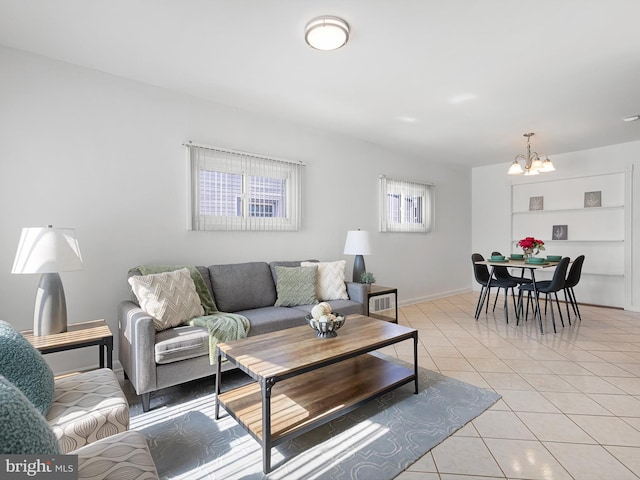 living room featuring light tile patterned flooring, baseboards, and an inviting chandelier