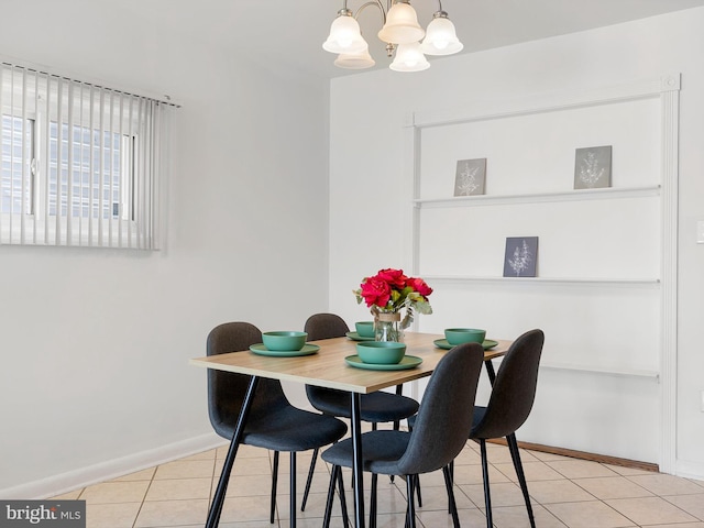 dining room featuring a notable chandelier, light tile patterned floors, and baseboards