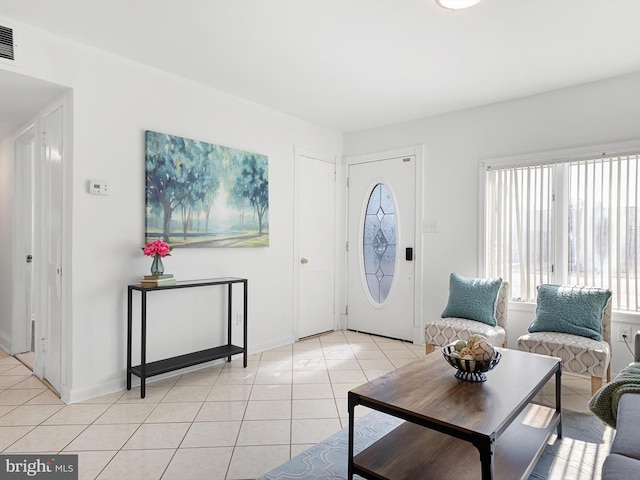 entryway featuring light tile patterned floors and baseboards