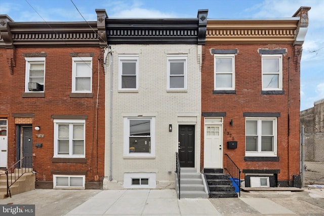 view of property with brick siding and entry steps