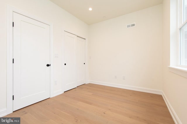 unfurnished bedroom with visible vents, recessed lighting, light wood-type flooring, and baseboards