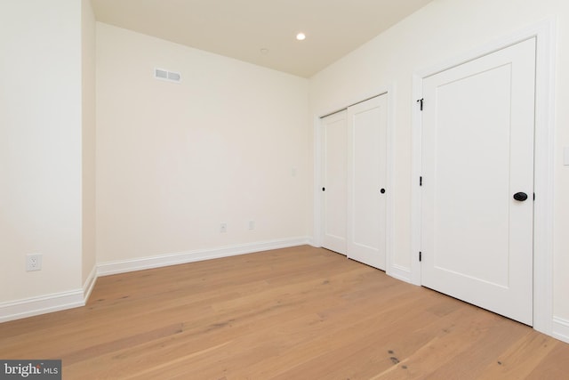 unfurnished bedroom with recessed lighting, visible vents, baseboards, and light wood-style floors