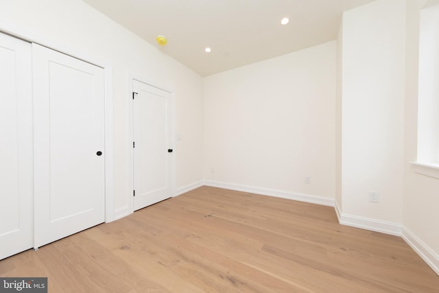 unfurnished bedroom featuring recessed lighting, baseboards, and light wood-style floors