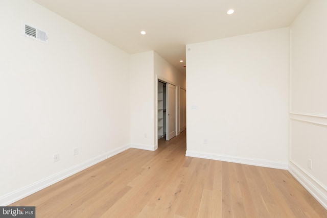 spare room with baseboards, recessed lighting, visible vents, and light wood-type flooring