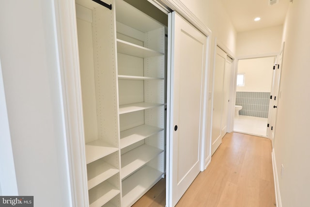 hall featuring recessed lighting and light wood finished floors