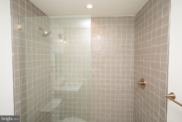 full bath with a tile shower