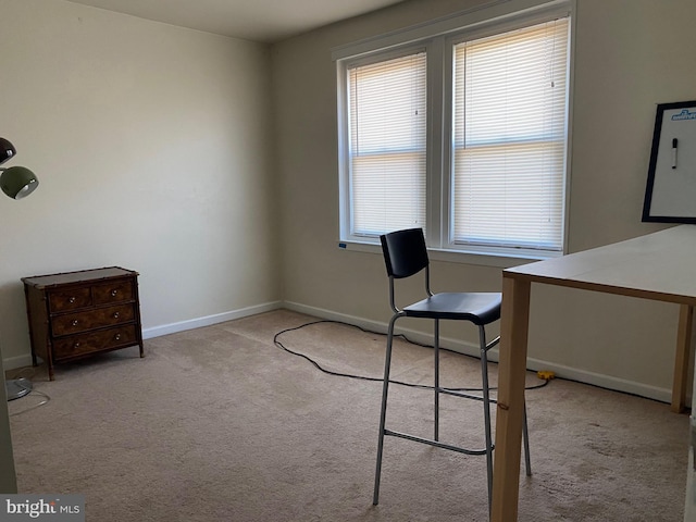 unfurnished office featuring baseboards and carpet floors