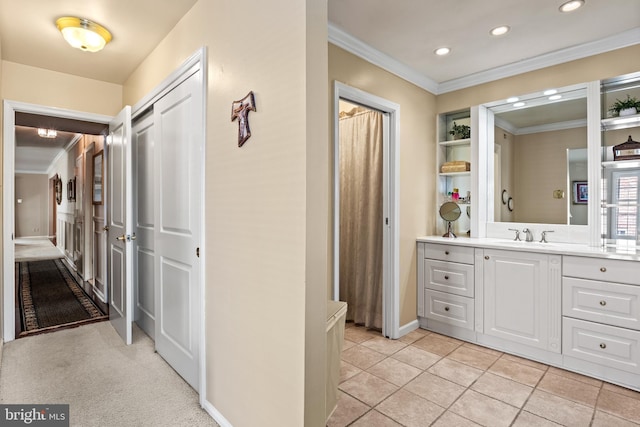 hall featuring light tile patterned floors, recessed lighting, crown molding, and a sink