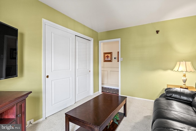 carpeted living area with baseboards