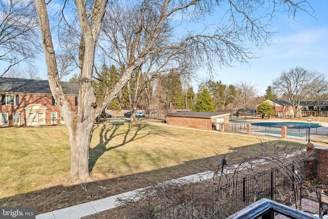 view of yard with a fenced in pool and fence