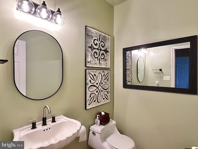 bathroom featuring toilet and a sink