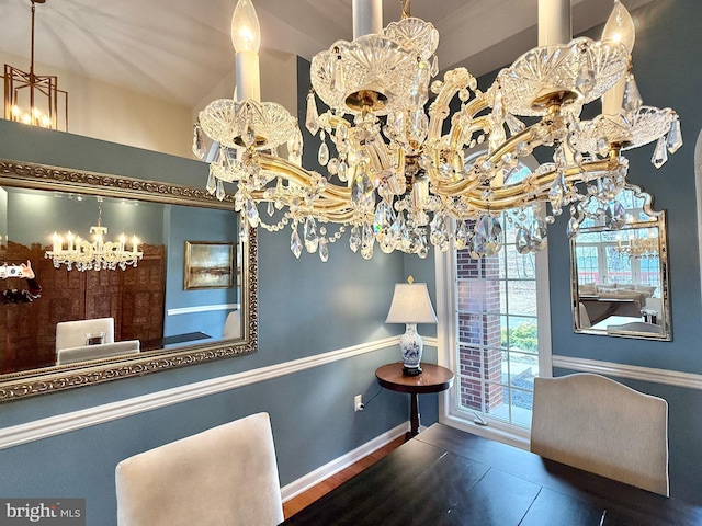 dining space with an inviting chandelier and baseboards