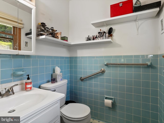 731 Fayette St, Cumberland, MD 21502 - half bath with a wainscoted wall, vanity, tile walls, and toilet