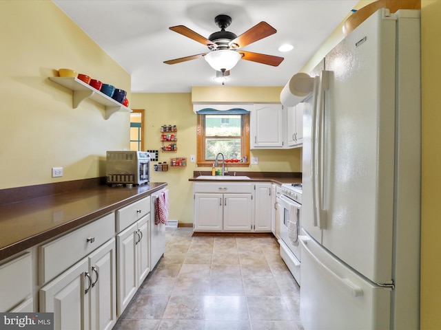 731 Fayette St, Cumberland, MD 21502 - kitchen with a sink, dark countertops, white cabinetry, ceiling fan, and white appliances