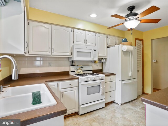 731 Fayette St, Cumberland, MD 21502 - kitchen featuring white appliances, white cabinets, dark countertops, and a sink