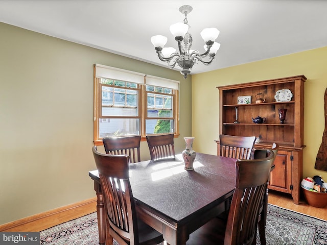 731 Fayette St, Cumberland, MD 21502 - dining room featuring a notable chandelier, light wood-type flooring, and baseboards