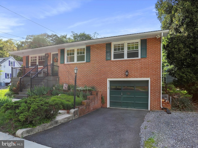 731 Fayette St, Cumberland, MD 21502 - view of front facade with brick siding, aphalt driveway, and an attached garage
