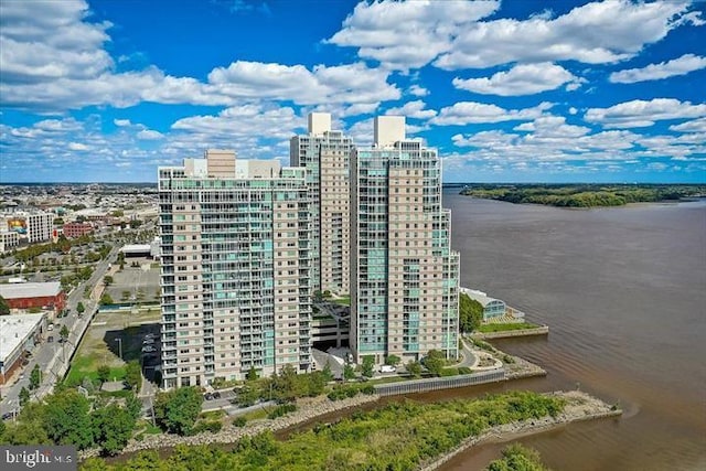 view of property featuring a water view and a view of city