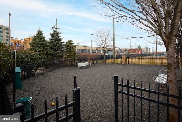 view of yard with central air condition unit and fence