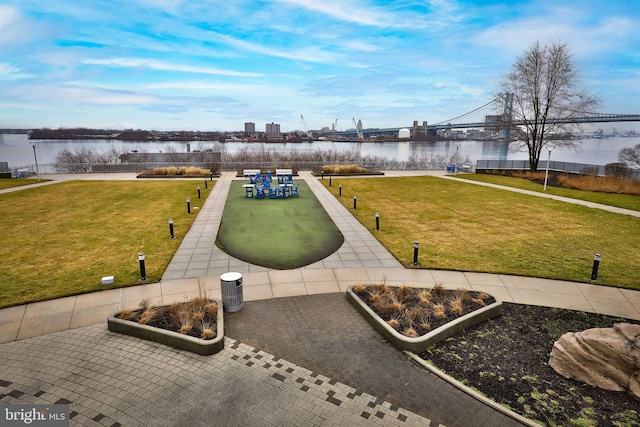 view of community with a yard and a water view