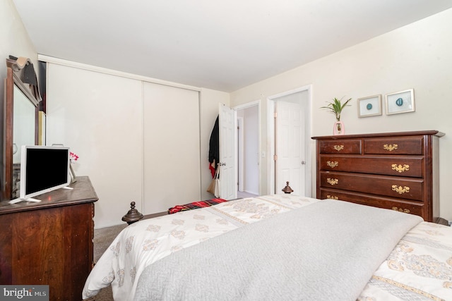 carpeted bedroom featuring a closet