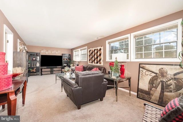 carpeted living area featuring baseboards