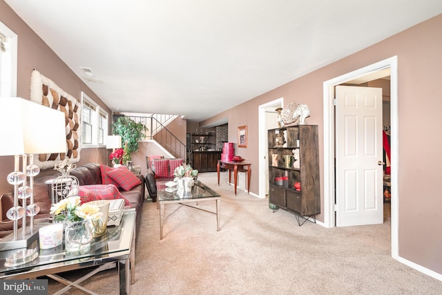 living room featuring visible vents, baseboards, and carpet flooring