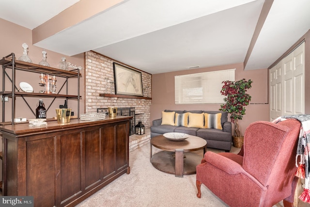 office space with a fireplace, visible vents, and light carpet